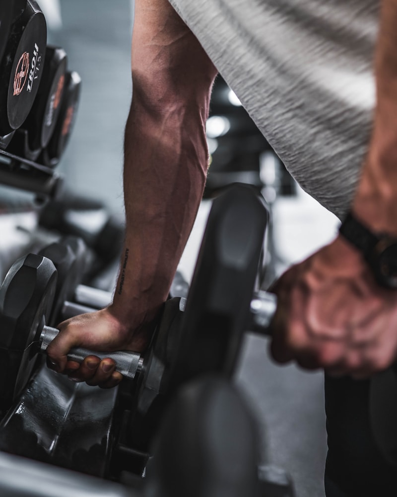 Athlete loading plates for a heavy strength session
