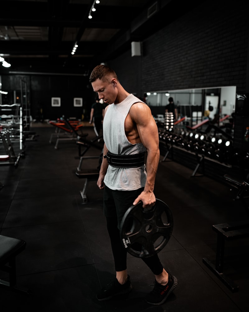 Open warehouse gym floor with rigs and plates